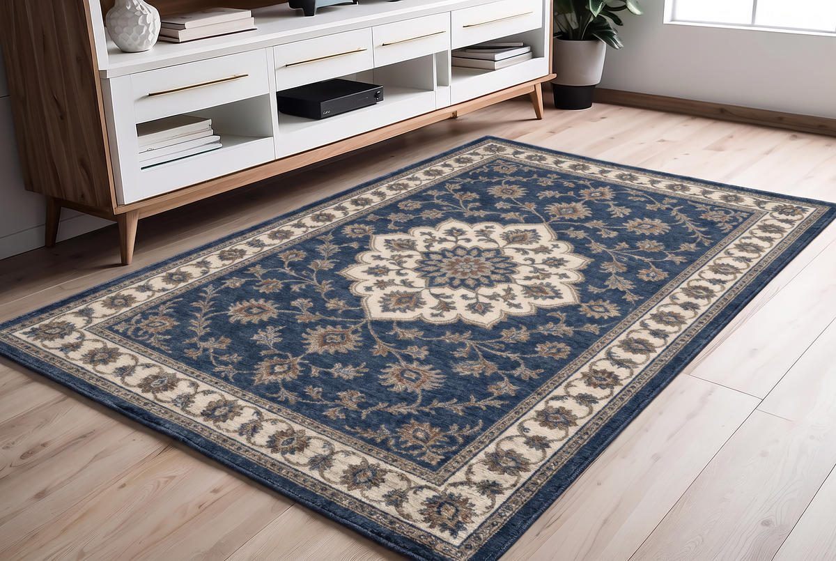 Navy Floral Medallion Rug, hand-tufted wool with navy medallion and ivory scrolling vine border, shown in a styled room