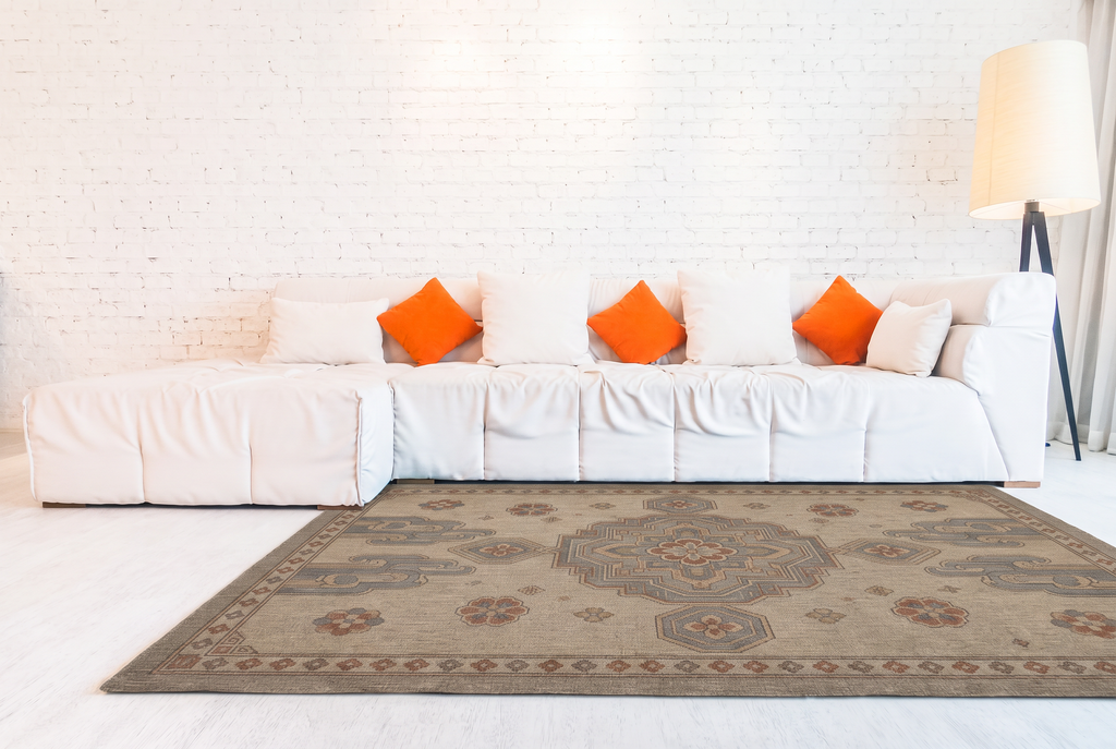 Cloud Scroll Medallion Rug, hand-tufted wool with slate blue medallion and cloud scrolls on greige, close-up view