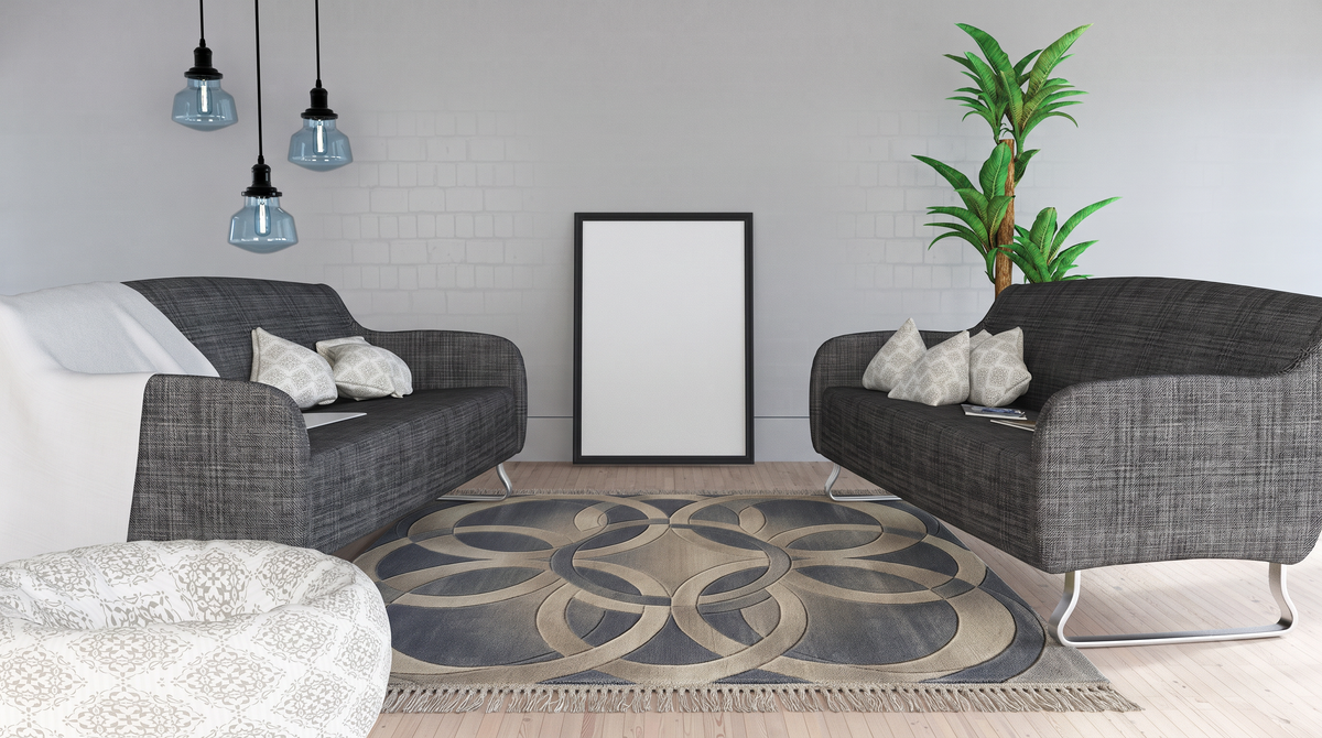 Slate Interlocking Rings Rug, hand-tufted wool with overlapping sand circles on slate blue, shown in a styled room