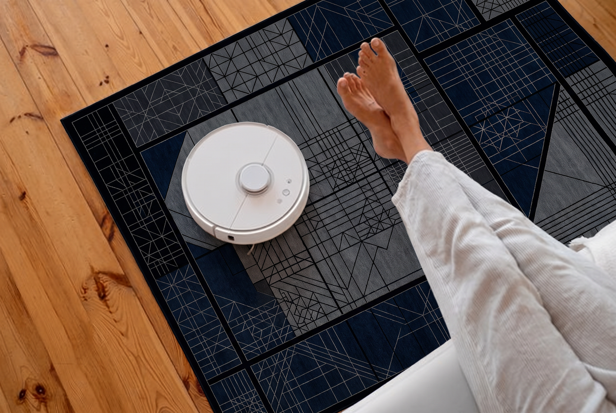 Midnight Blueprint Grid Rug, hand-knotted Indo-Nepali wool with a black grid of charcoal, grey and navy panels in fine blueprint line work, pile close-up
